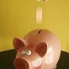 coin into piggy bank