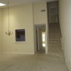 our new living room from the back door - view of the stairs to our bedroom, kitchen, hallway, and office